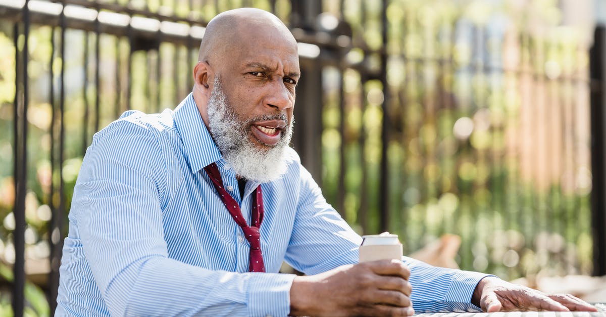 Can I do a break-of-journey on Thalys? - Sullen black man sitting at table with drink