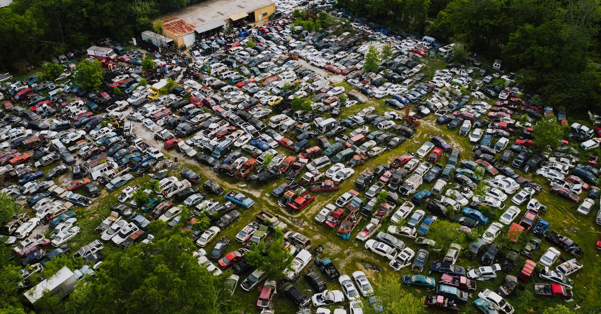 Can I enter and leave Thailand with two different passports? - Parking for old decayed vehicles on green lawn