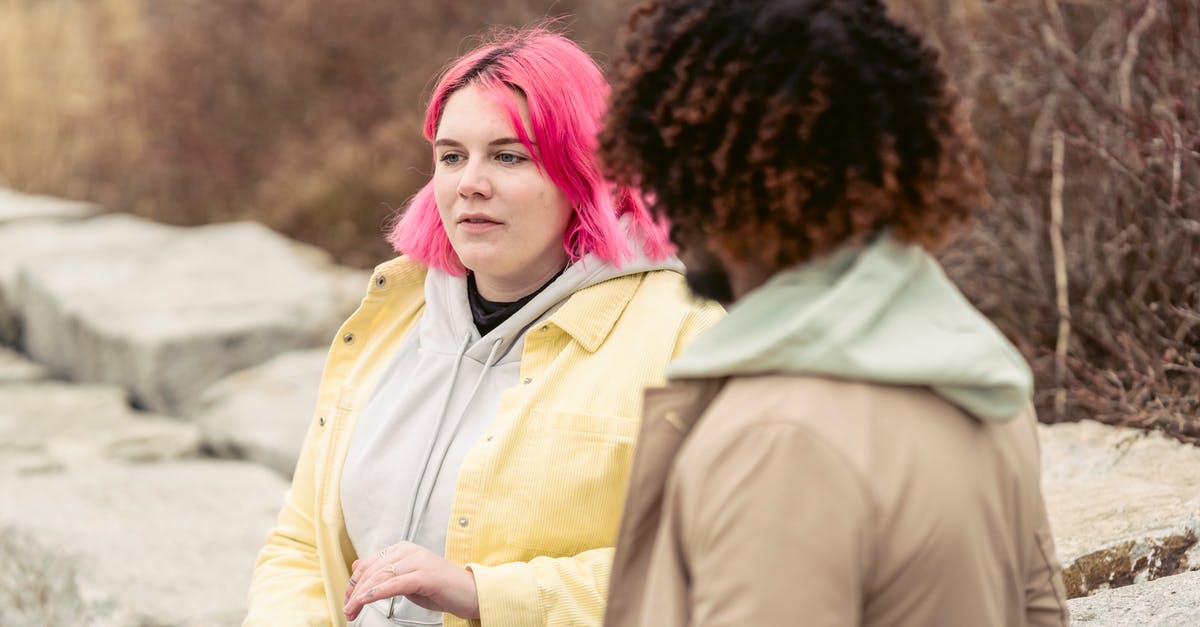 Can I extend the dates of my already given Schengen visa? - Calm plump female with pink hair and can of soda in hand sitting near faceless African American man during date