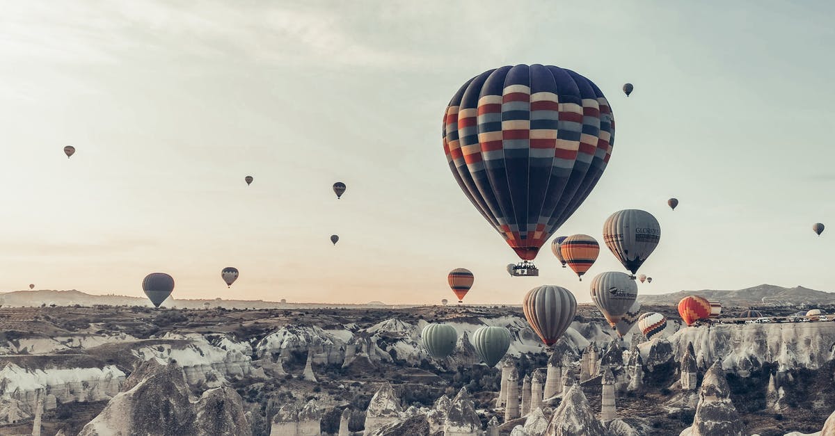 Can I fly to (board) Turkey without passport? - Multicolored hot air balloons flying above famous vast rocky valley in Cappadocia Turkey on early morning on fair weather