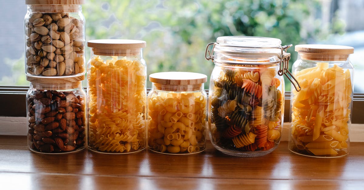 Can I gain entry into the Schengen area through Spain if my visa is a Type D Italian visa? - Glass jars filled with assorted types of uncooked pasta and pistachios with almonds placed on wooden table near window in light room