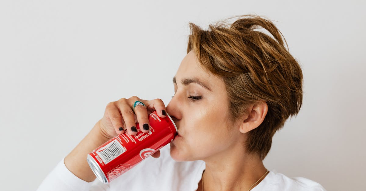 Can I get a UK Visa at short notice? - Thirsty woman enjoying coke from colorful can