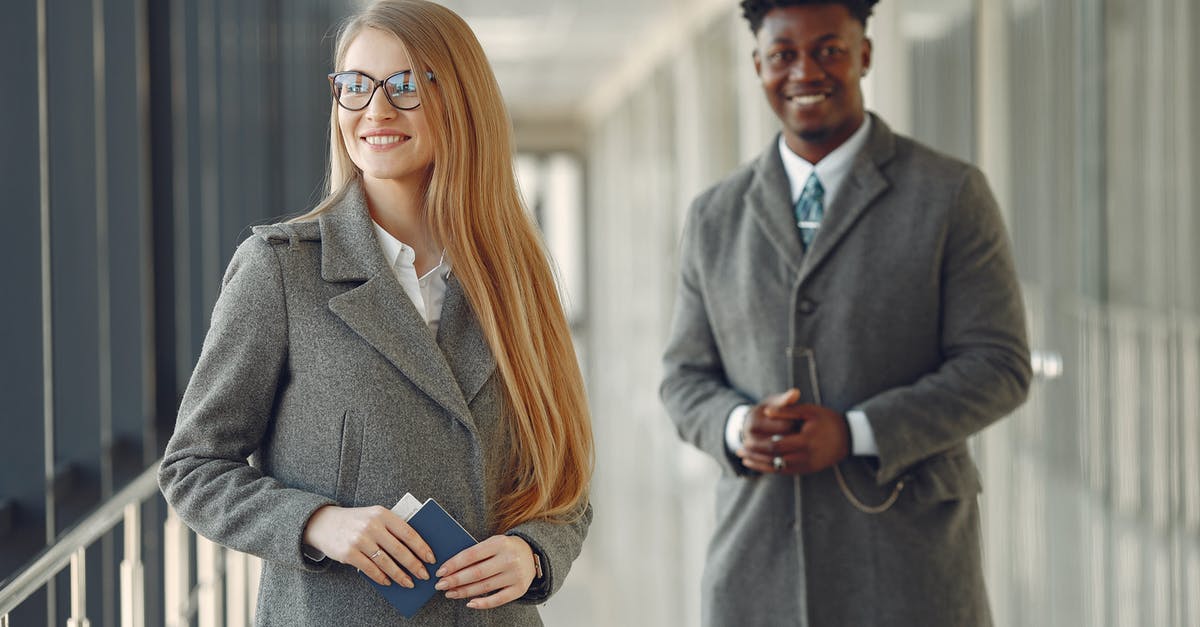 Can I join a connecting flight from second airport? - Cheerful business people with passport in airport hall