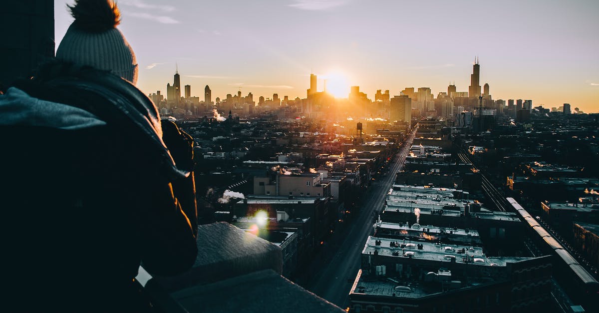 Can I leave Chicago (ORD) on a 10 hour layover - Man in Black Jacket Standing on Top of Building during Sunset