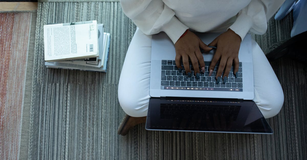 Can I make my connection from Heathrow to Kings Cross? [duplicate] - Top view of anonymous African American female student sitting with crossed legs and typing on netbook sitting near stack of books