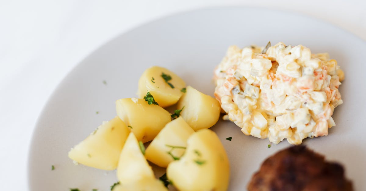 Can I pre-order a meal on a Russian train? How? - From above of plate with juicy fried meat cutlet served with delicious Russian meat salad and boiled potatoes topped with parsley placed on white table