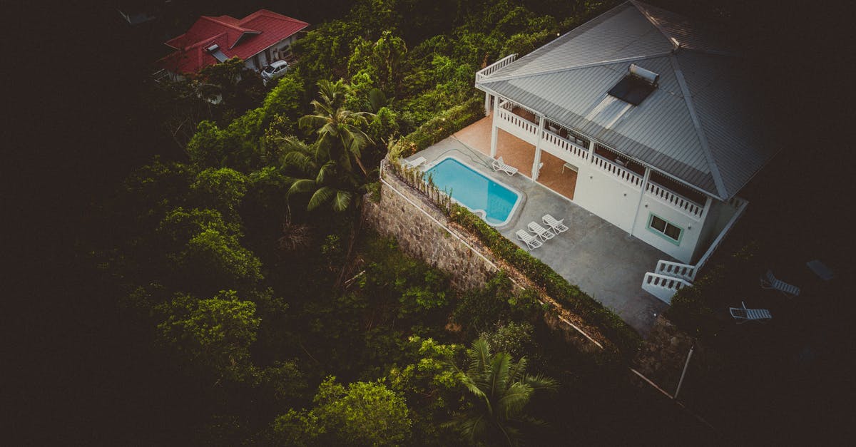 Can I purchase Seychelles island currecy in Malaysia? - White and Grey House With A Pool Surrounded By Vegetation