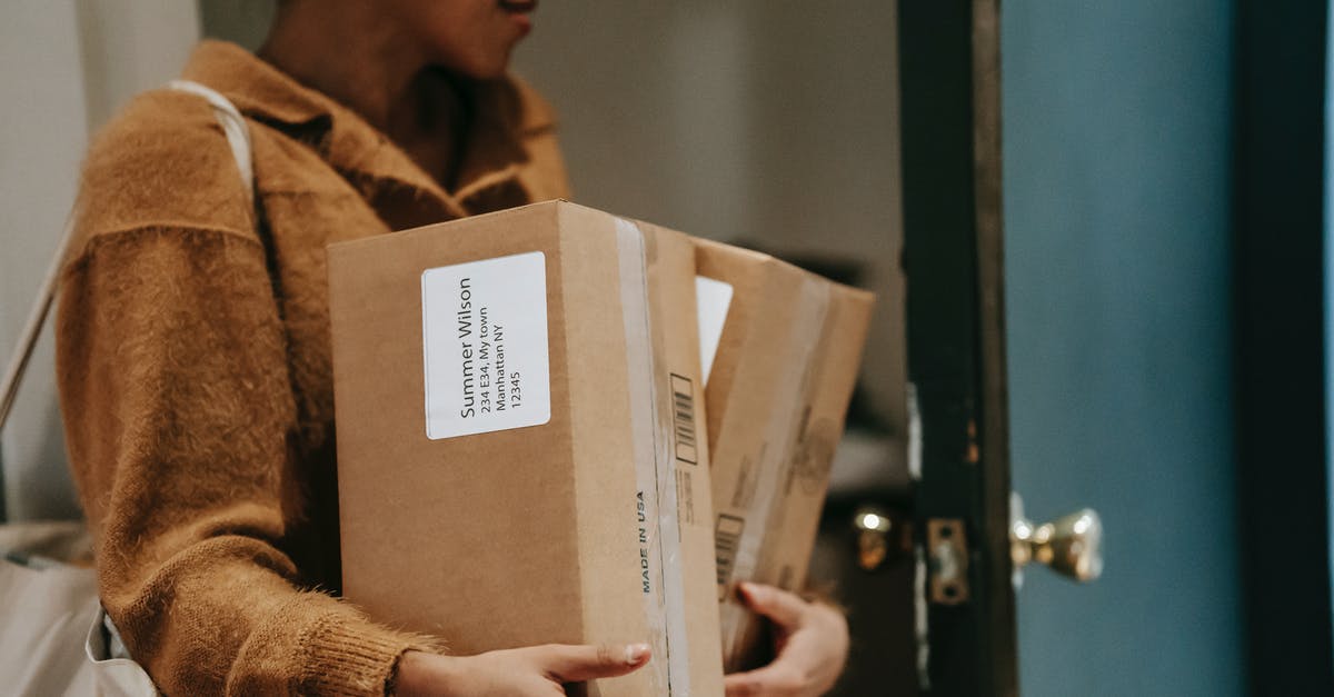 Can I receive a package in Zurich airport while on transit? - Crop ethnic female walking into open door of apartment with carton boxes with goods from delivery