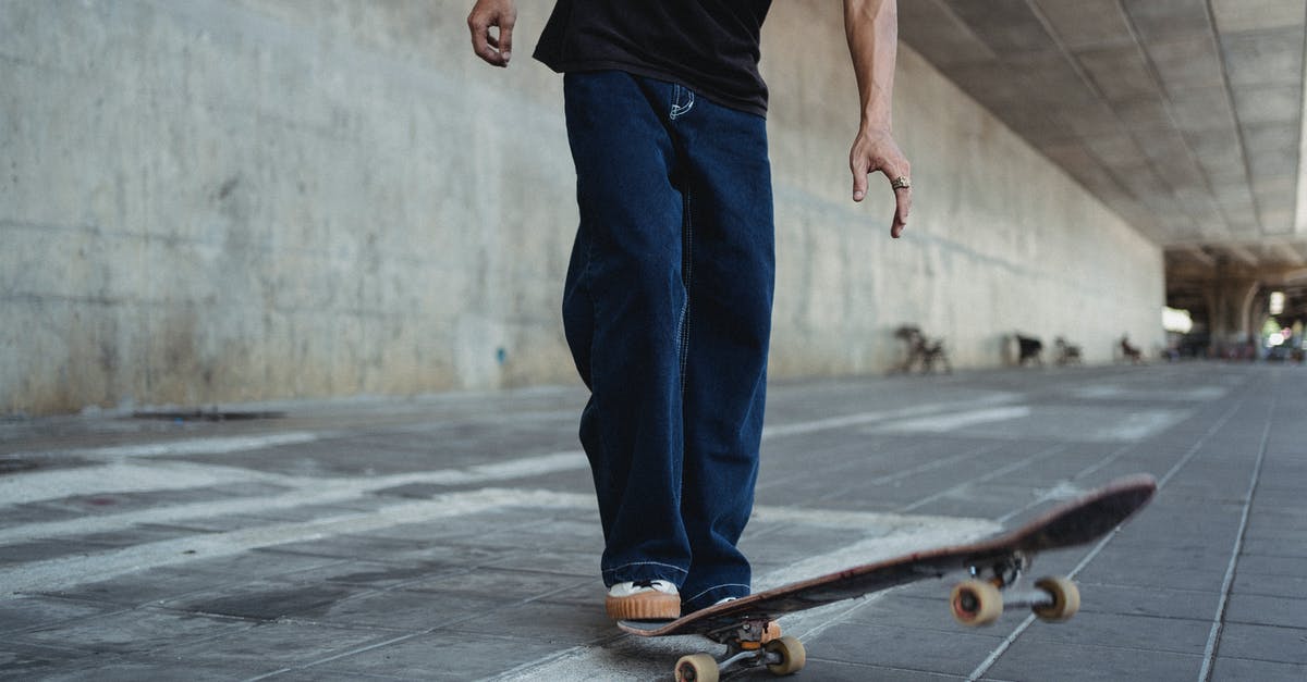 Can I roller skate on the street in France? - Crop man with skateboard on street