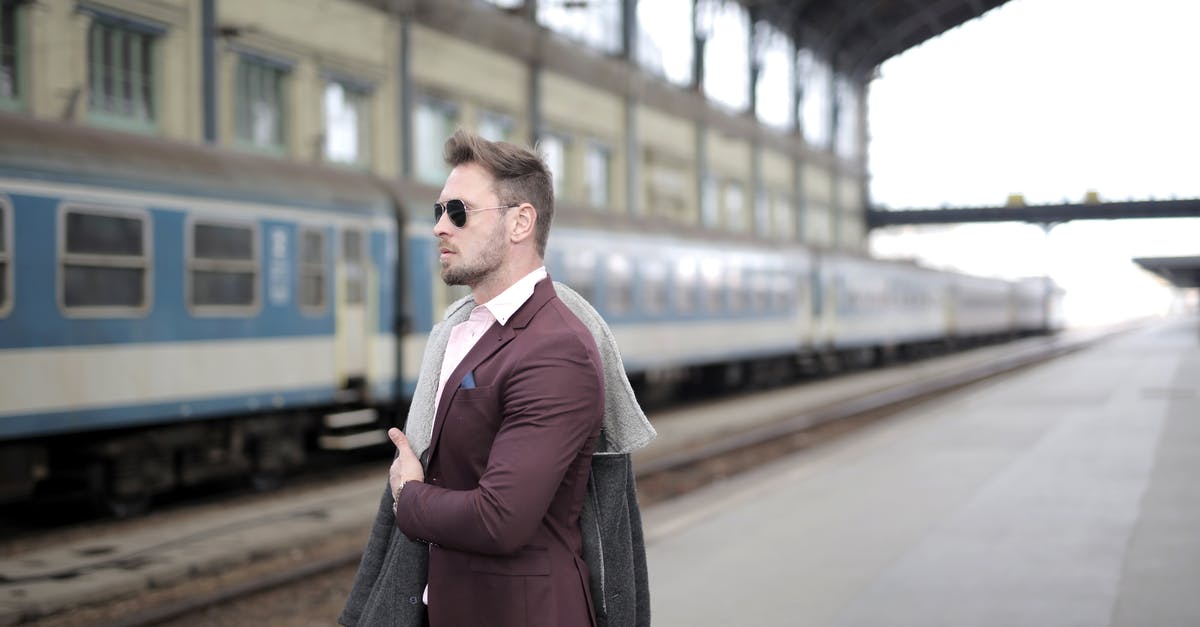 Can I search for European train connections avoiding certain stations? - Confident stylish passenger standing on railway station and waiting for departure