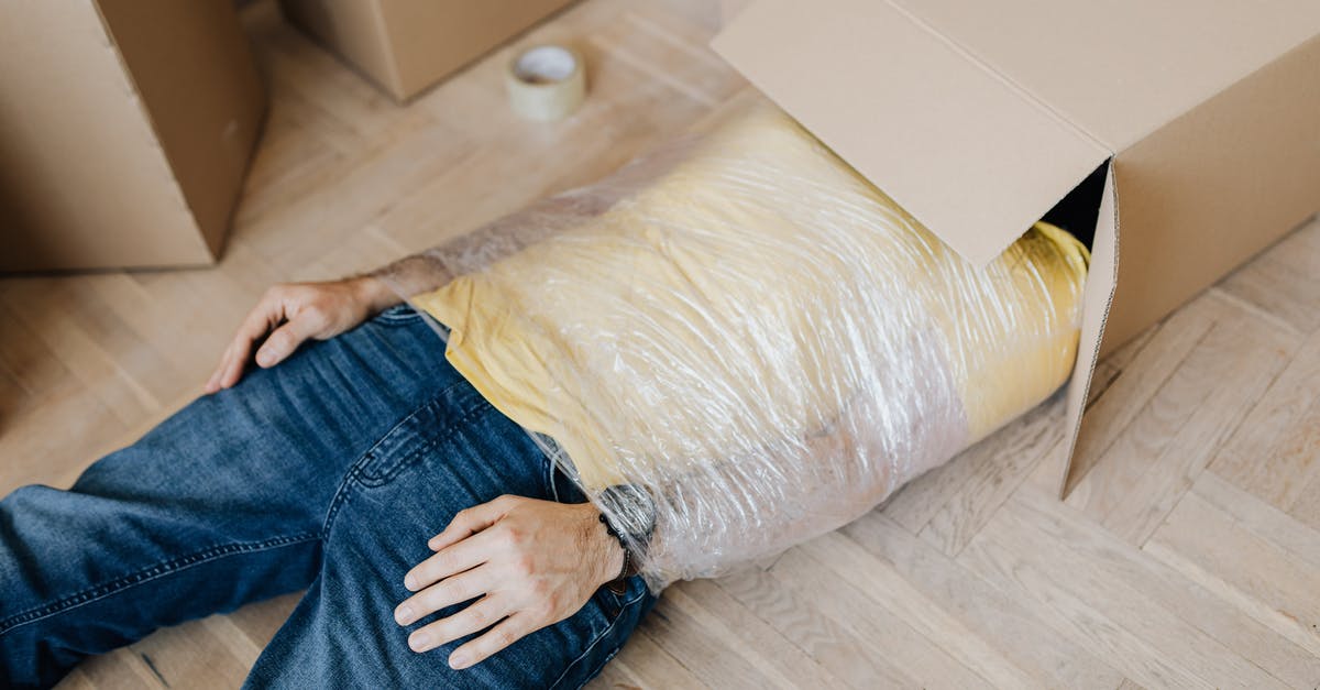 Can I simply bubble wrap a cardboard box and check it on a US domestic flight? - Man tied up using tape with head in carton box Can I simply bubble wrap a cardboard box and check it on a US domestic flight? - Man tied up using tape with head in carton box