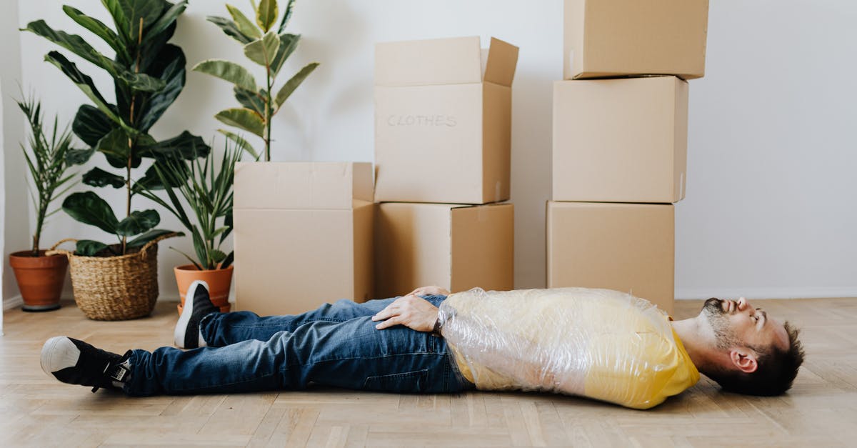 Can I simply bubble wrap a cardboard box and check it on a US domestic flight? - Full body side view unemotional male wearing casual outfit lying on floor with upper body tied up with tape and tired after packing belongings into carton boxes Can I simply bubble wrap a cardboard box and check it on a US domestic flight? - Full body side view unemotional male wearing casual outfit lying on floor with upper body tied up with tape and tired after packing belongings into carton boxes