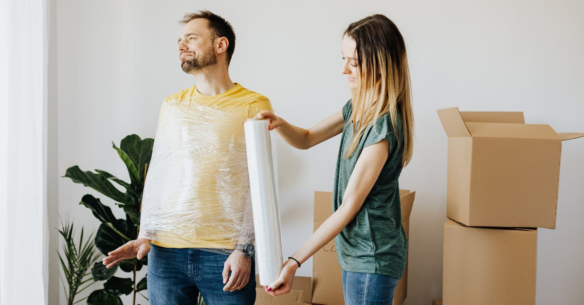 Can I simply bubble wrap a cardboard box and check it on a US domestic flight? - Content couple having fun while girlfriend in casual wear wrapping boyfriend with clingy plastic roll during packing belongings into carton boxes before moving in together Can I simply bubble wrap a cardboard box and check it on a US domestic flight? - Content couple having fun while girlfriend in casual wear wrapping boyfriend with clingy plastic roll during packing belongings into carton boxes before moving in together