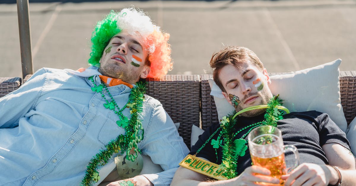 Can I sleep on a bench at St Petersburg Moskovsky station? - Football fans resting with mug of beer on terrace of bar