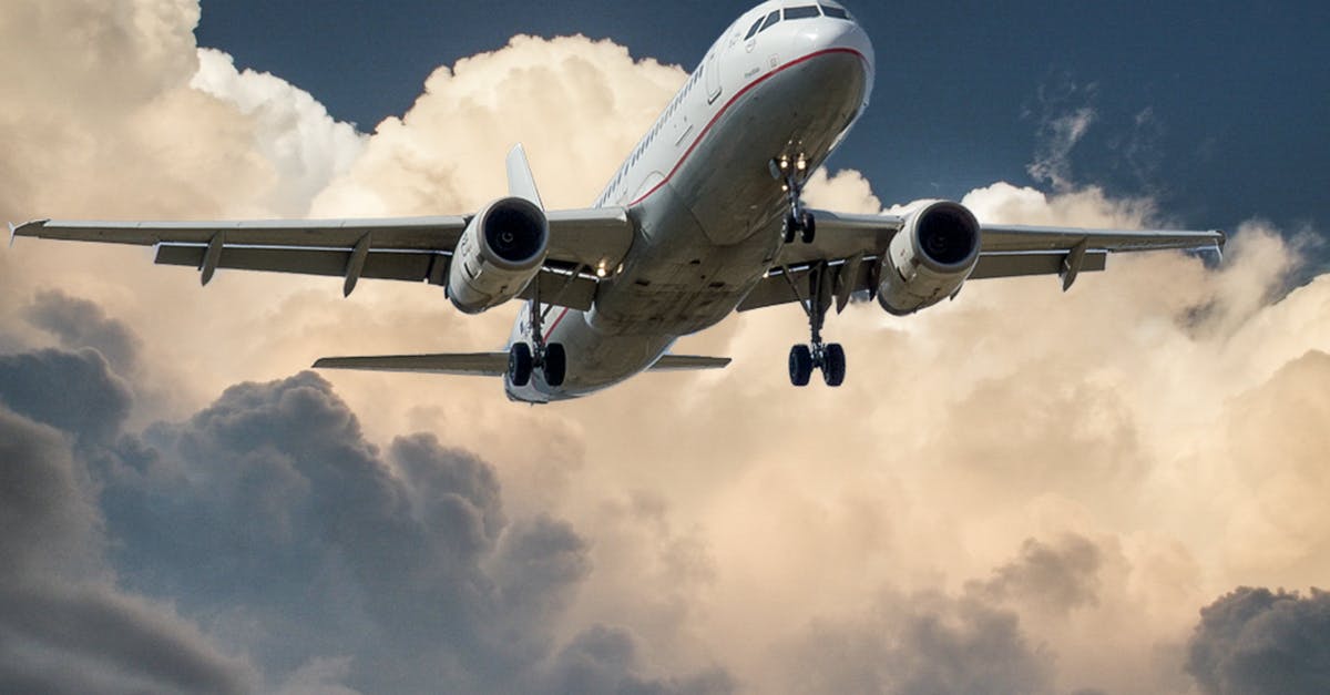 Can I stay in the airplane toilet during landing? - White and Red Plane Beside Clouds Low-angle Photography