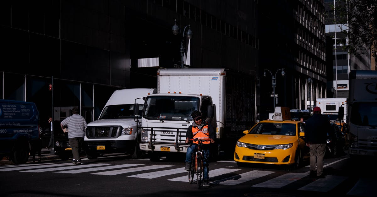 Can I take a bicycle on the Windsor/Detroit truck ferry? - People Walking on Pedestrian Lane in Front of Vehicles