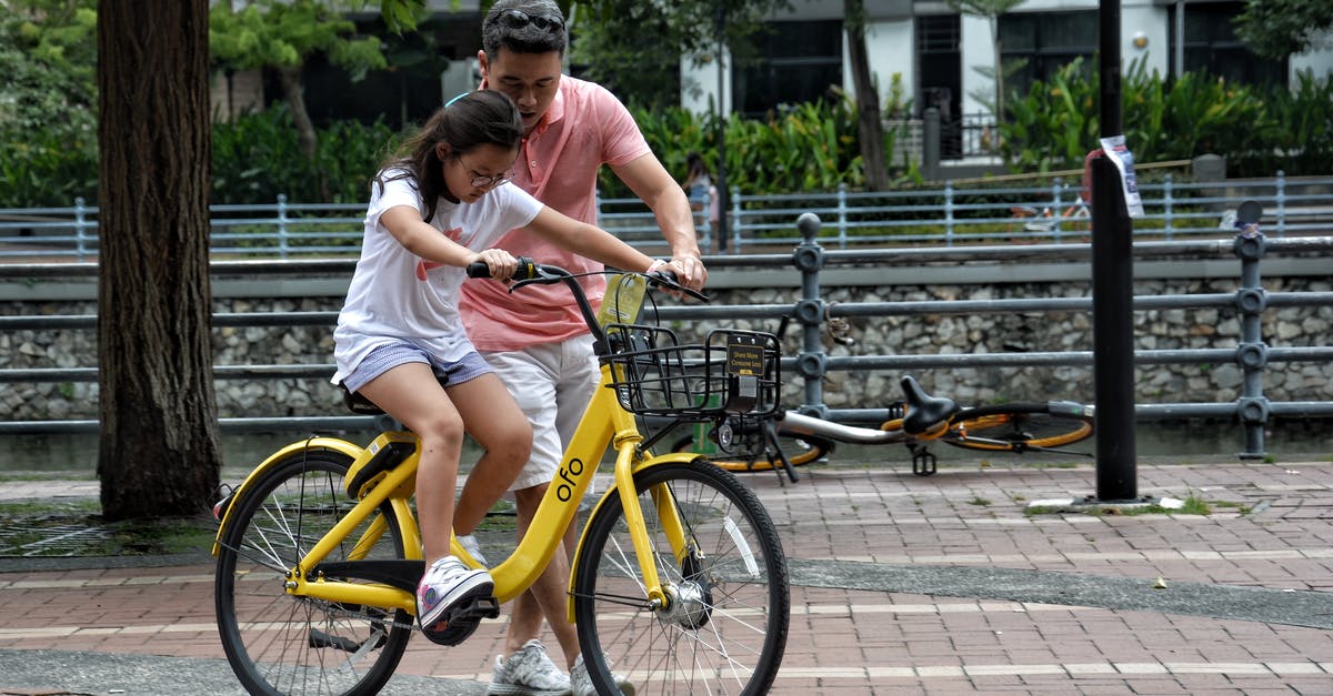 Can I take a boxed bicycle on a German train? - Photography of Girl Riding Bike Beside Man