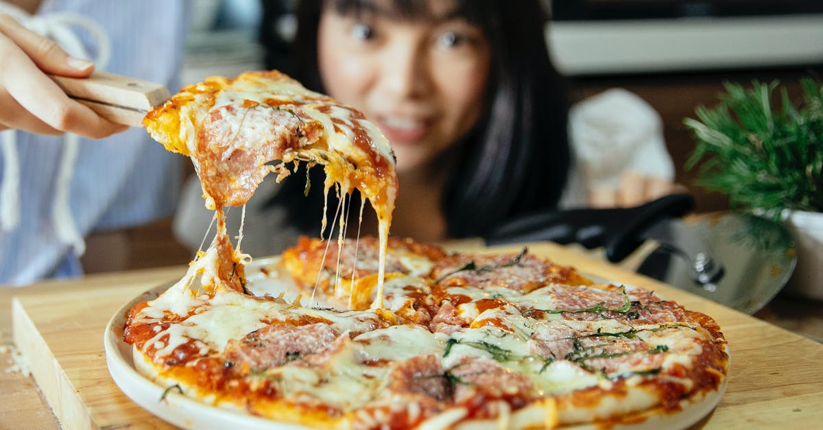 Can I take an extra piece of luggage to the USA? - Women taking piece of pizza with tomatoes and cheese