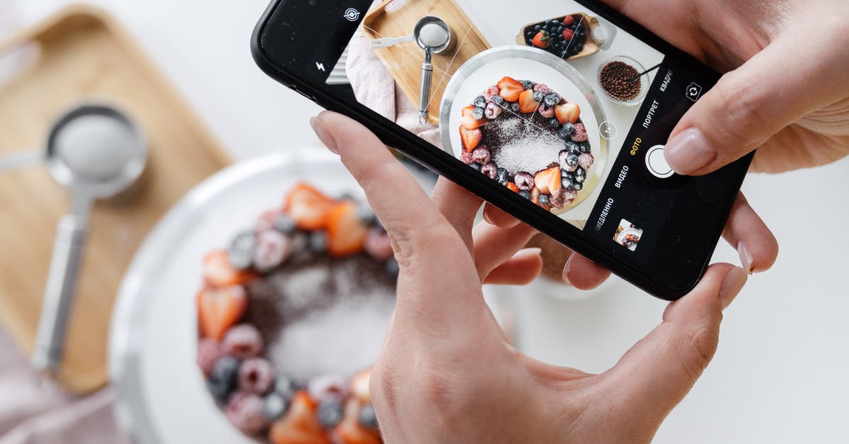 Can I take chocolate to Australia? - Woman hand taking photo on smartphone of delicious decorated cake