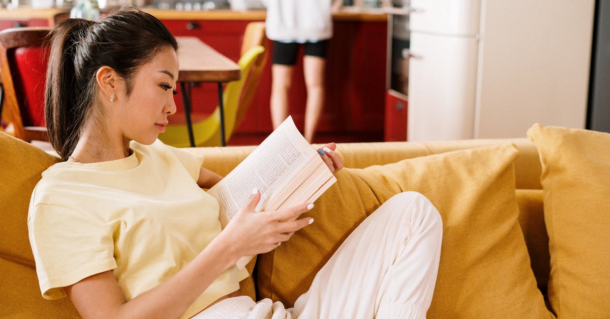 Can I track my ticket that my company may have booked? - Boy in Yellow Crew Neck T-shirt Reading Book