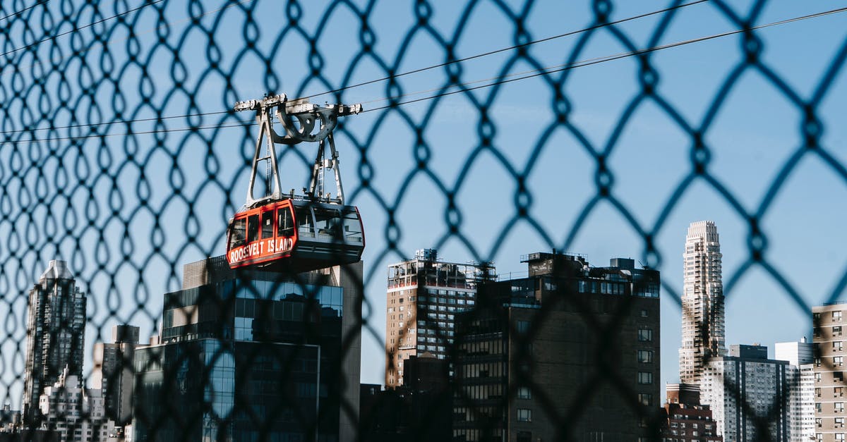 Can I transit through the US without a visa? - Cable car against modern district in city