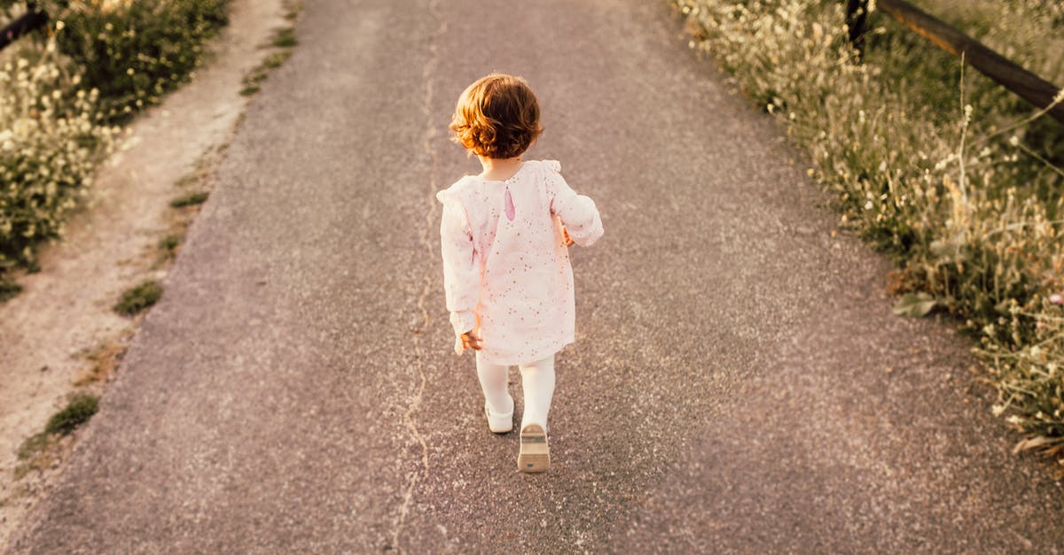 Can I travel alone on a UK Child Visit visa? - Girl Wearing White Clothes Walking on Pavement Road