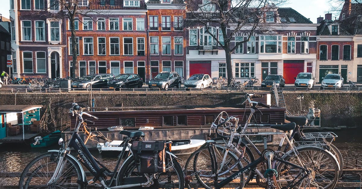 Can I travel in the International IC between Dutch cities? - Bicycles Parked Beside Brown Wooden Fence Near A River