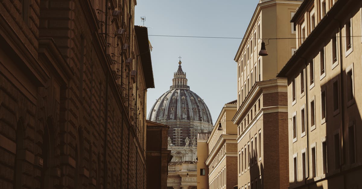 Can I travel to Italy with a permesso based on old passport? - Saint Peters Cathedral between old buildings