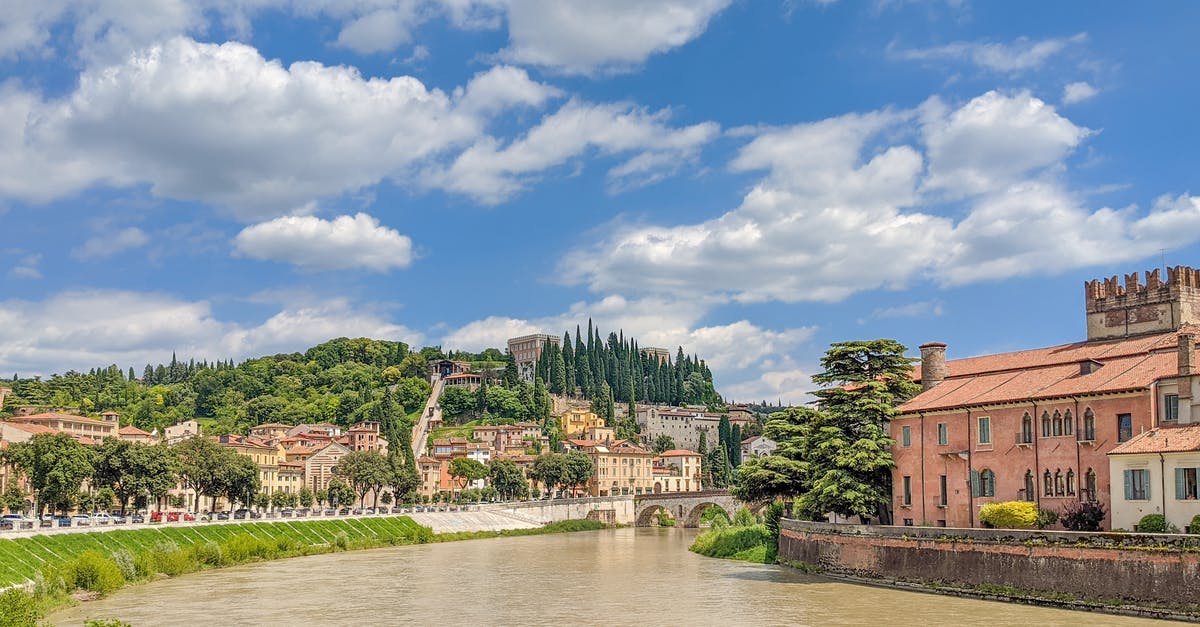 Can I travel to Italy with Bulgarian Visa? - Brown Concrete Building Near River Under Blue Sky