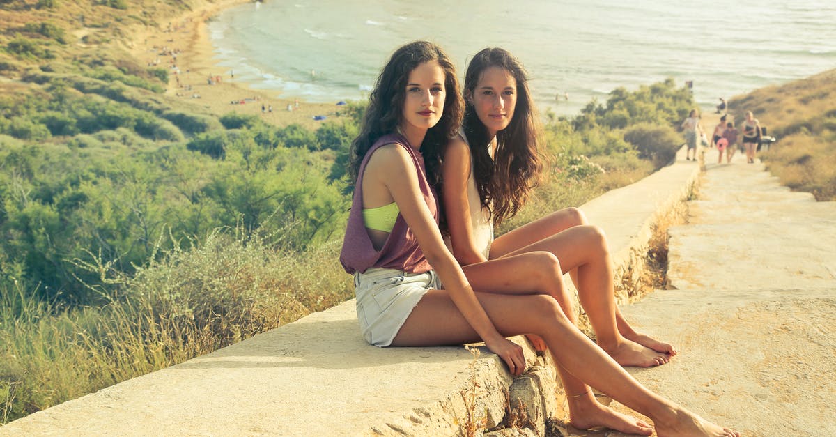 Can I travel to Malta without a visa? - Photo of Teenage Girls Sitting on the Pavement