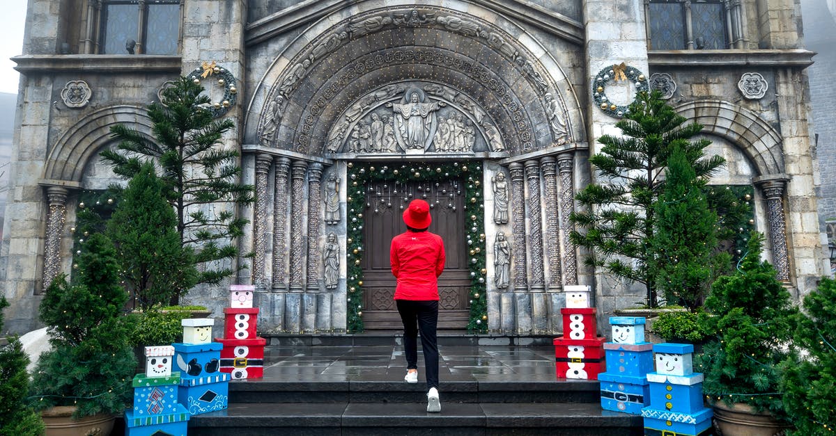 Can I travel to Vietnam for Christmas in 2020? - A Woman in Red Jacket Standing at the Doorway