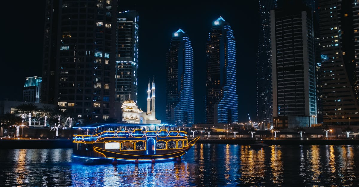 Can I travel without a visa by boat from Dubai to Ireland? - A Boat Sailing on River Near City Buildings during Night 