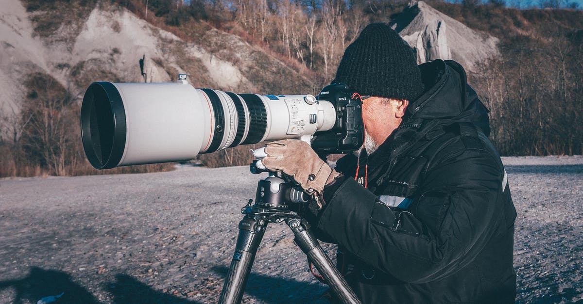 Can I use a telephoto lens during takeoff or landing? - Man Taking Picture Using a Camera With Telephoto Lens