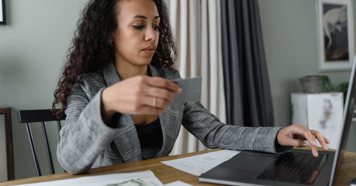 Can I use Hong Kong dollars in Guangzhou? - A Woman Using a Laptop Near Cash Money