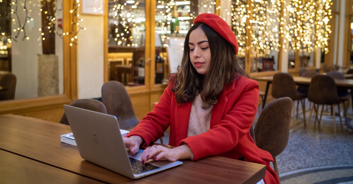 Can I use only buses in Paris instead of the Métro? - Woman in Red Coat Using Laptop on Wooden Table