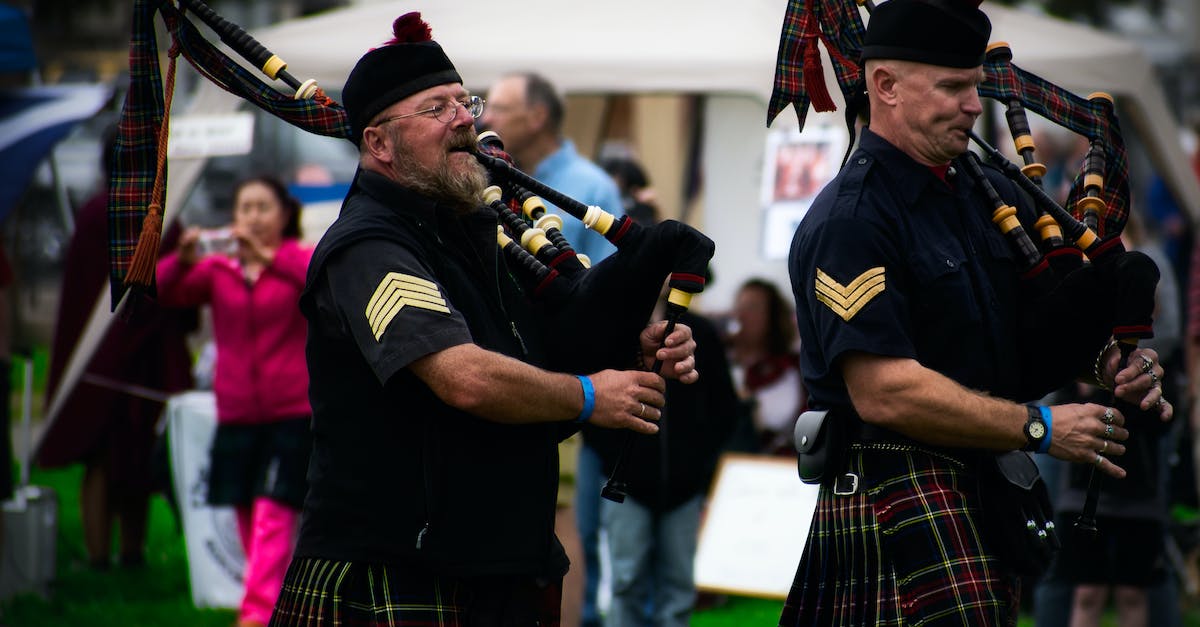 Can I wear a kilt around Europe? - Two Men Playing Wind Instruments on Ground