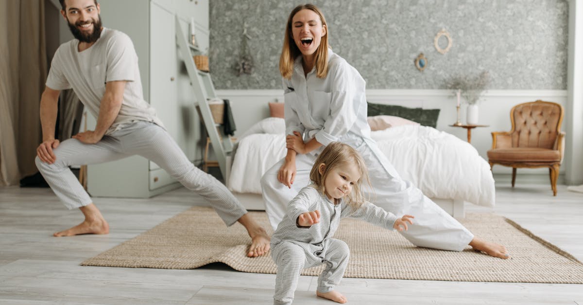 Can my father enter the UK as an EEA family member? - Woman in White Scrub Suit Sitting on Floor Beside Girl in White Dress