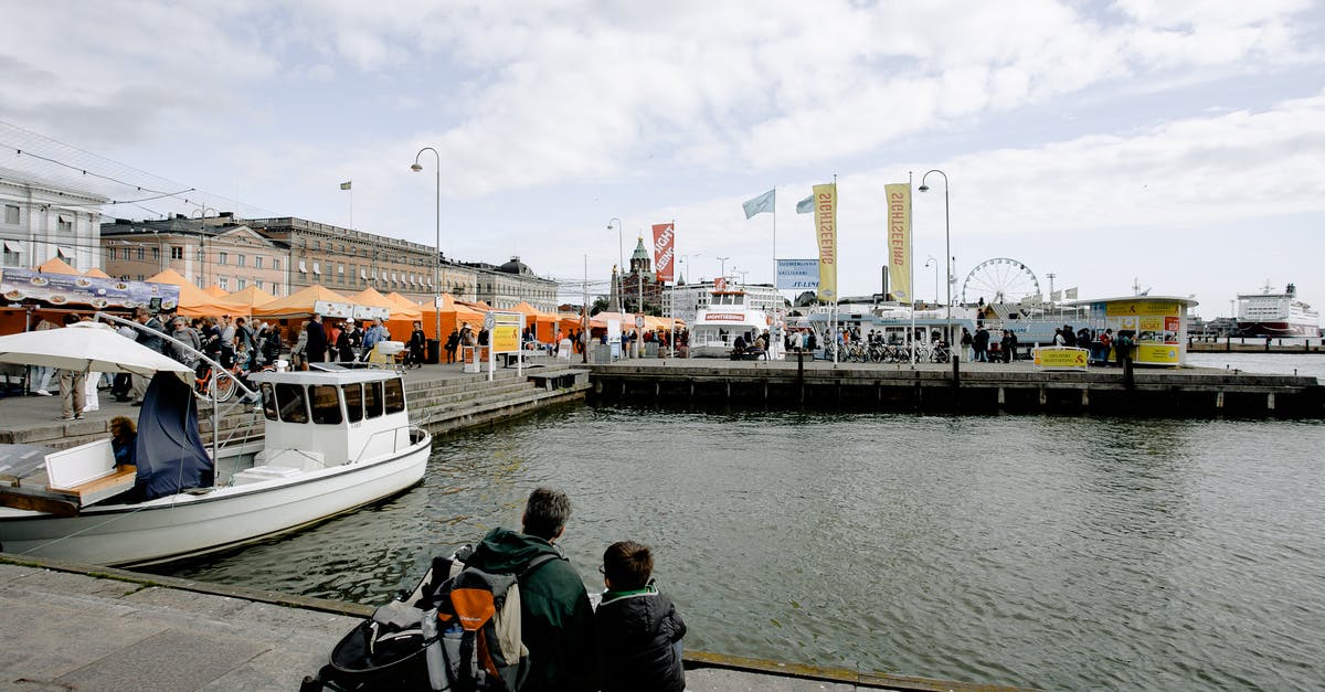 Can my son travel to Denmark while banned from entering Sweden? - Anonymous father with son sitting near lake with motor boat