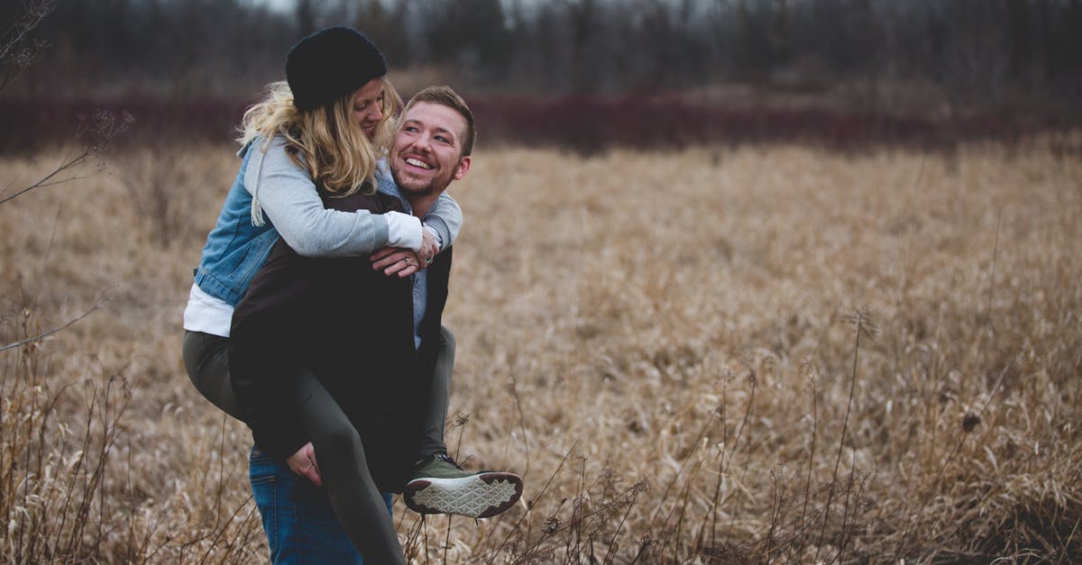 Can my wife leave the UK while on a spouse visa? - Photo of a Man Carrying His Partner