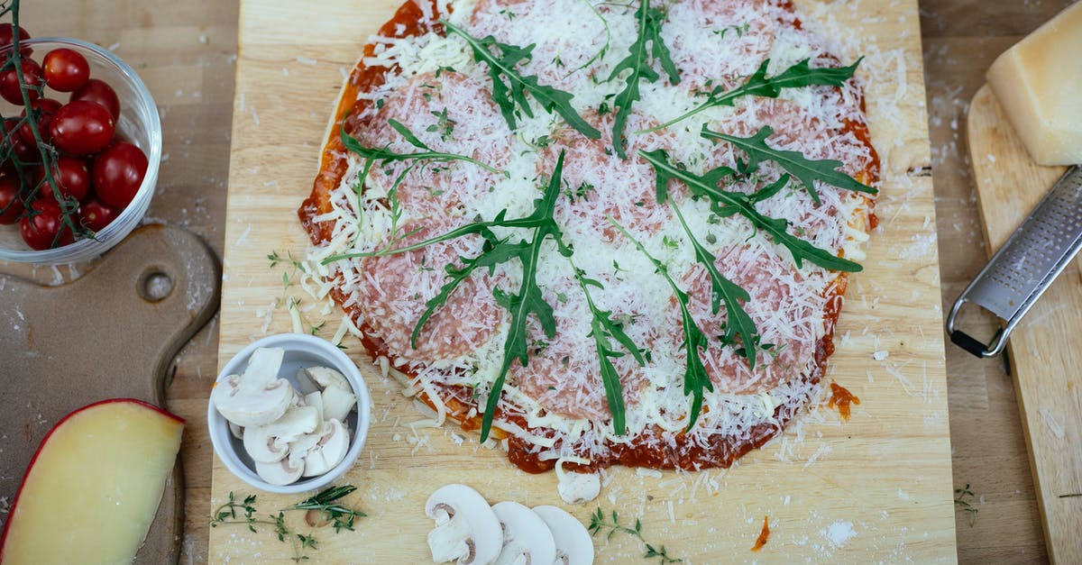 Can one export spices and teff flour from Ethiopia? - Uncooked pizza with herbs on kitchen table