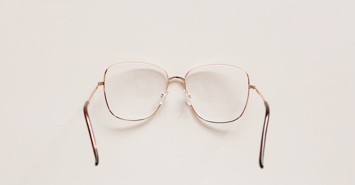 Can one see Morocco from Portugal? - Top view of fashion spectacles with transparent optical lenses in golden metal shell placed on white table