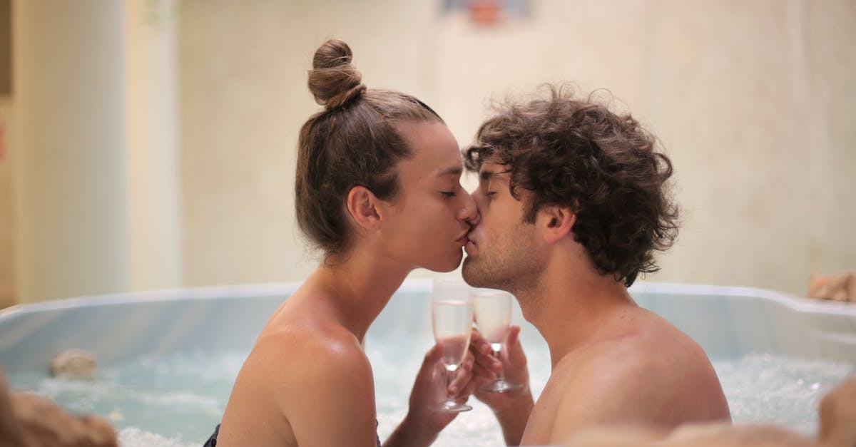 Can one take away hotel slippers? [duplicate] - Happy couple kissing in bath during romantic leisure at home