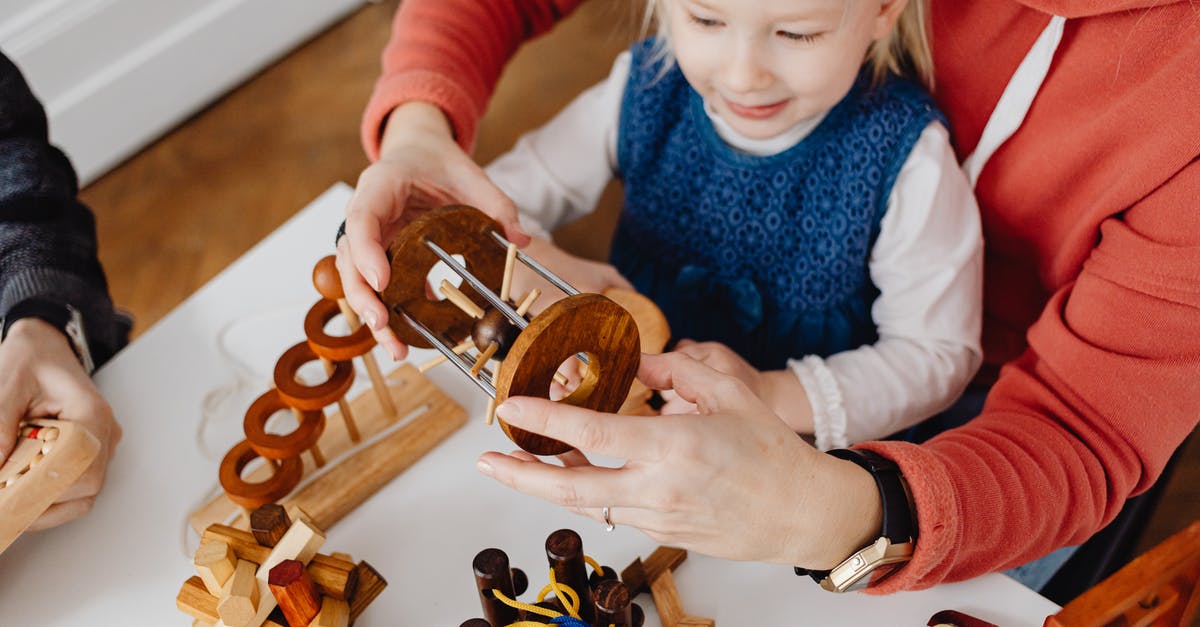 Can one take wooden toys to Australia? - Overhead Shot of a Person's Hands Solving a Puzzle