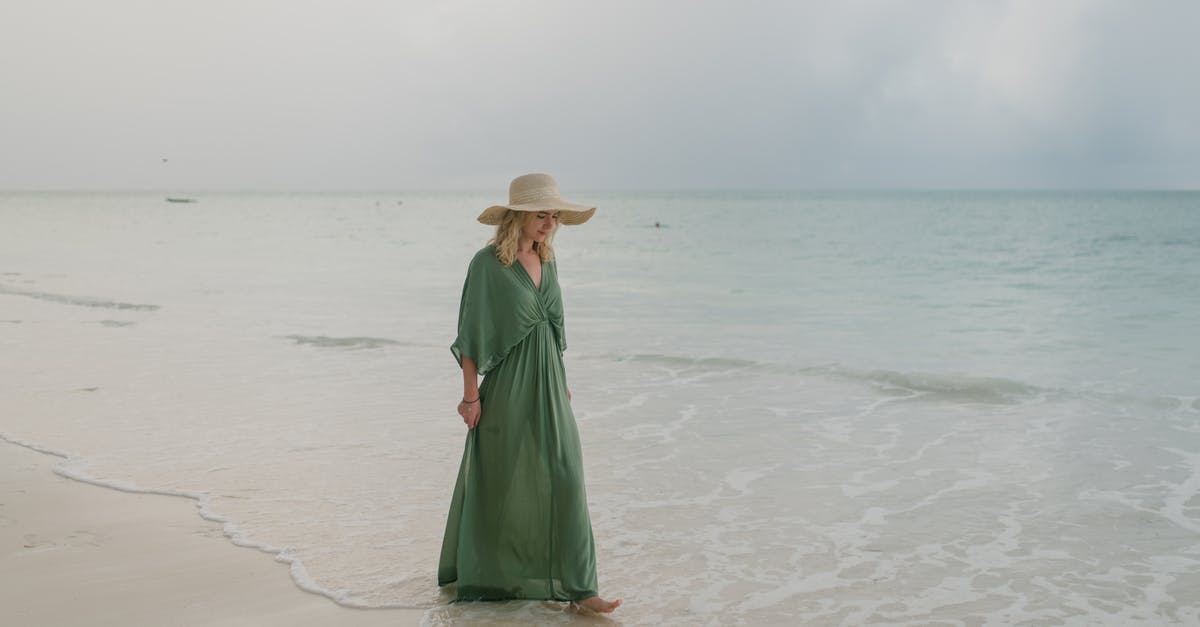 Can one wave down the inter-town minibuses in Thailand? - Full body of young female tourist wearing long summer dress and hat strolling on sandy seashore in tropical resort