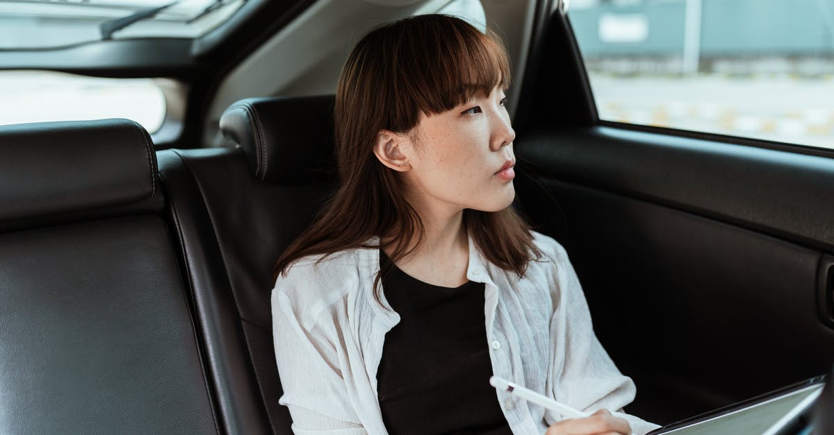 Can UK student visa refusal impact on Australian Student visa application? - Thoughtful young woman working on tablet with stylus in car