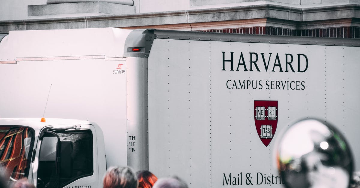 Can Visa delivery get delayed beyond travel dates? - White Harvard Campus Services Truck