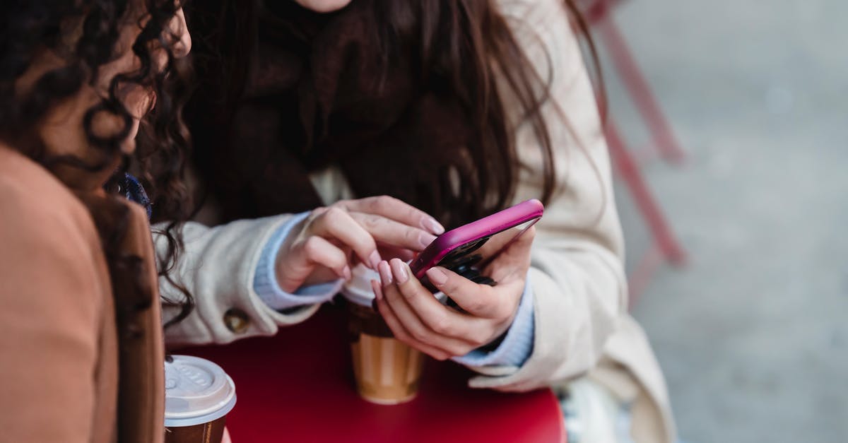 Can we share the Go Pass? - Women scrolling smartphone while having coffee in cafe