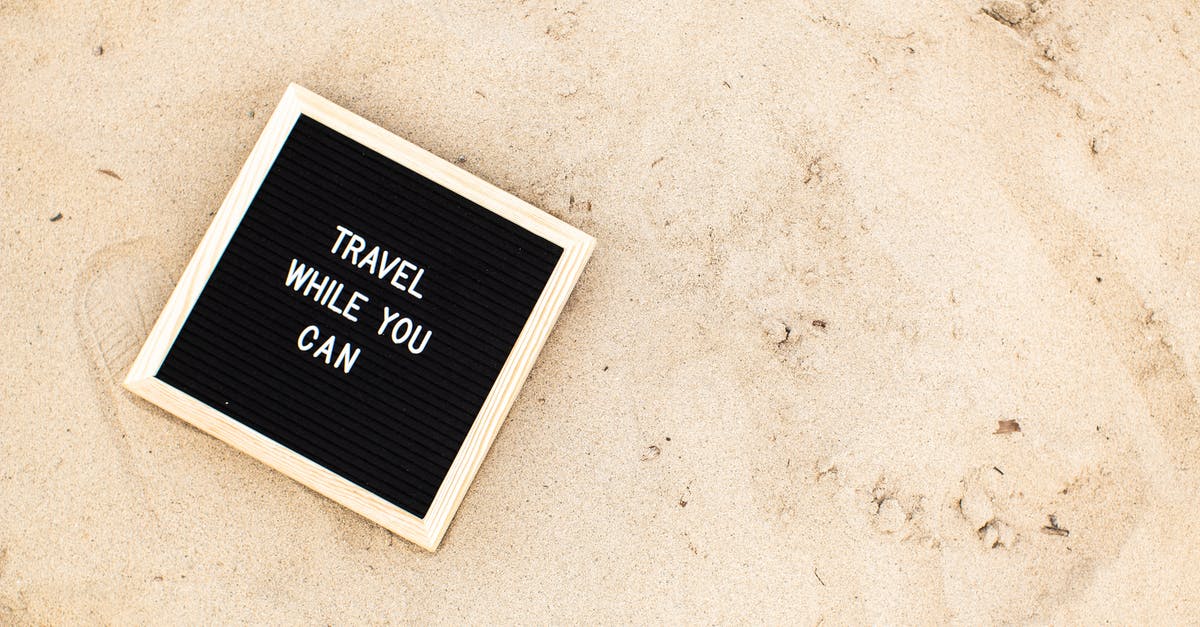 Can you be denied boarding in Italy for not having a visa to the UK? - A Letter Board with Travel While You Can on the Beach Sand