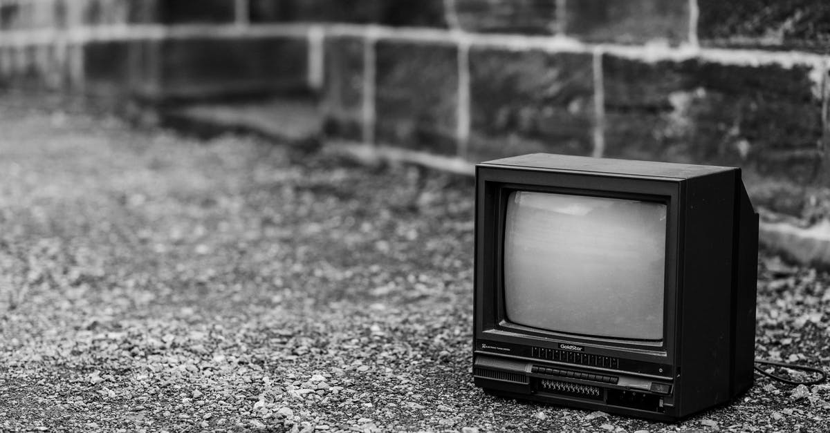 Can you bring a used TV into Nepal? [closed] - Black and white of old fashioned television placed on pathway near stone fence in city on street on blurred background