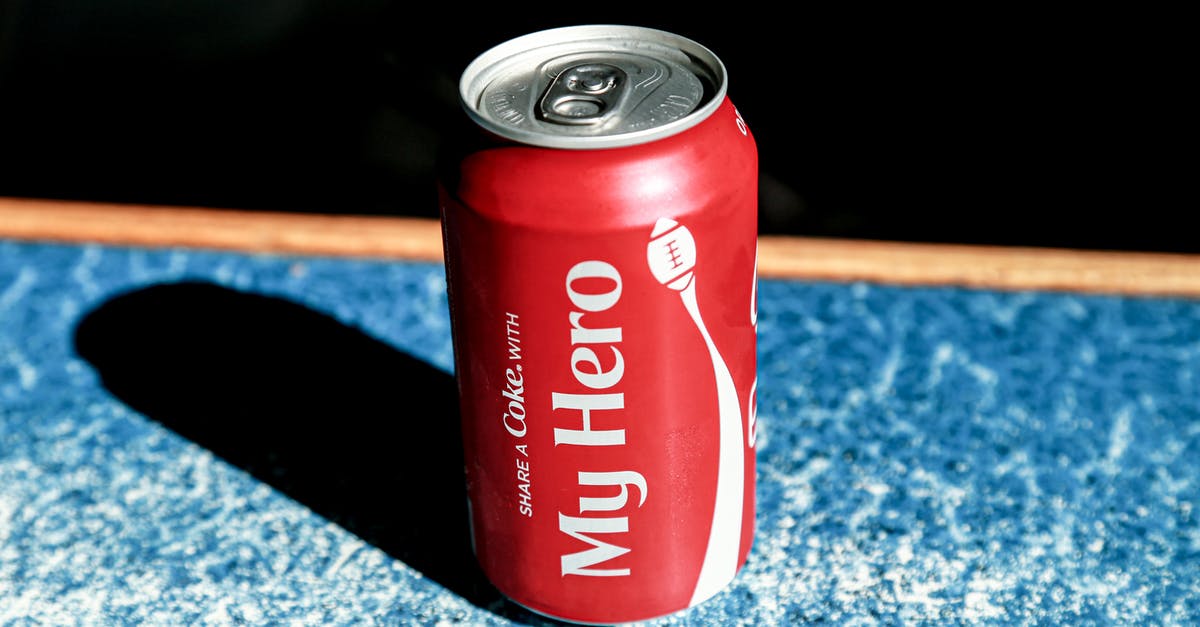 Can you freeze liquids to pass security checks? - From above of red metal can with refreshing fizzing coke placed on table in cafe